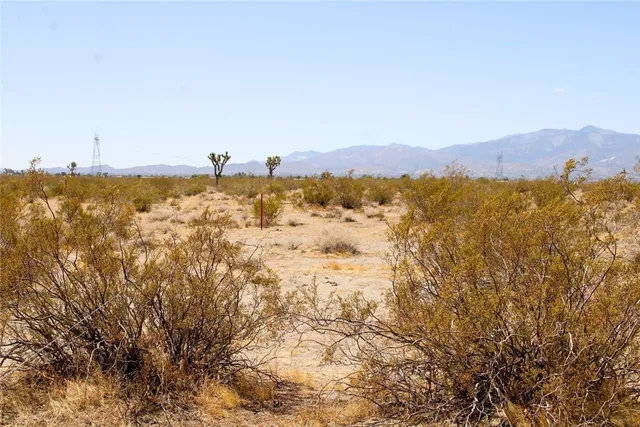 a view of mountain with sunset in background