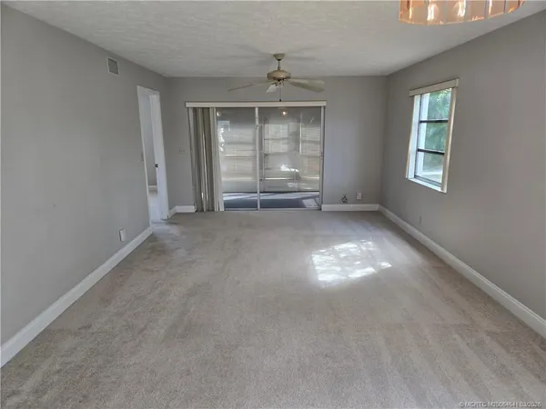 an empty room with windows and closet