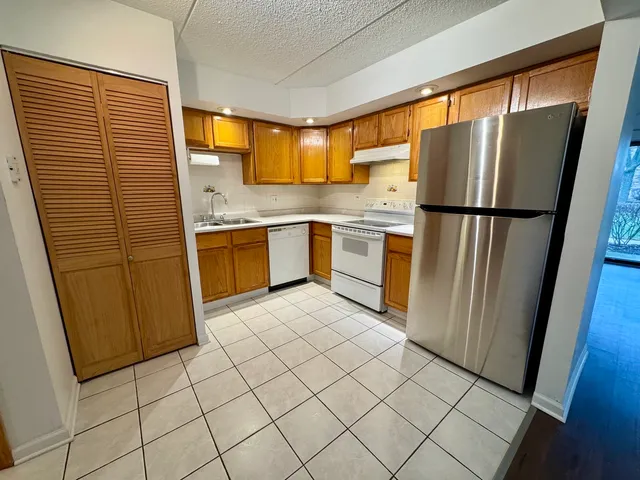 a kitchen with stainless steel appliances a refrigerator sink and microwave