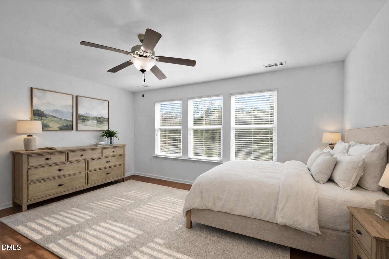 115 Writing Rock Place Apex, NC 27539 - Photo 13 of 31 a spacious bedroom with a large bed and a window