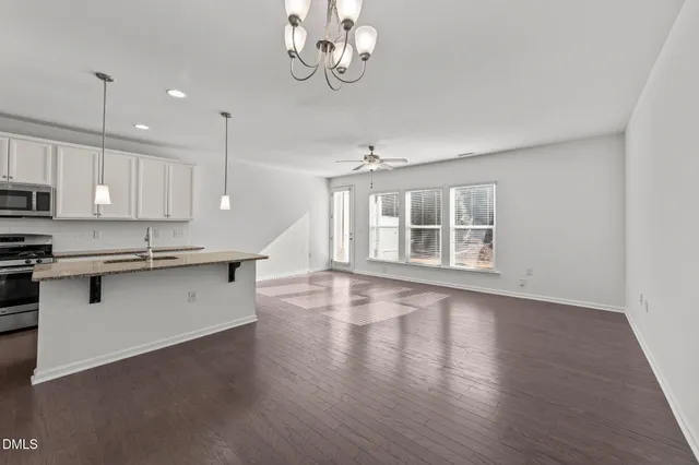 a large kitchen with stainless steel appliances granite countertop a large stove a sink dishwasher and a oven with wooden floor