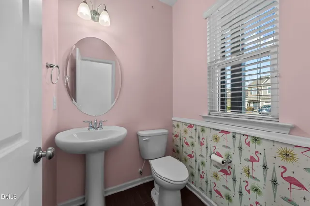 a bathroom with a toilet sink and mirror