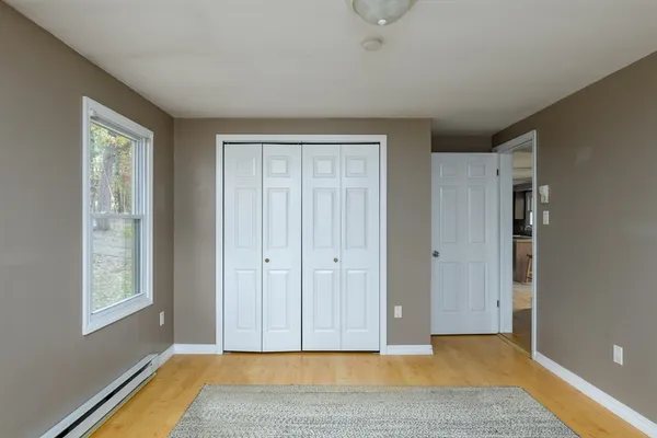 a view of room with window and wooden floor