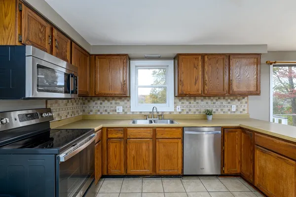 a kitchen with a sink stove top oven and cabinets