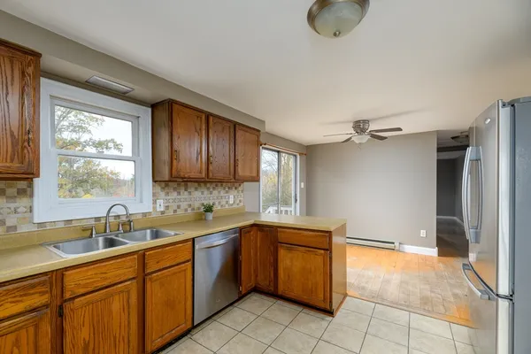 a kitchen with a sink cabinets and window