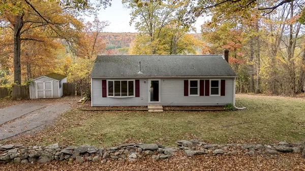 a house that has a tree in front of it