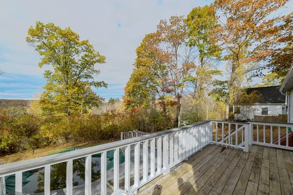 a balcony with wooden floor and fence