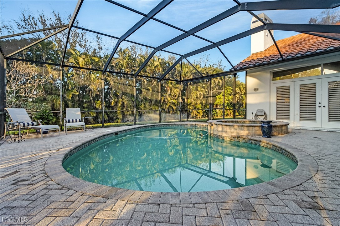 15661 Fiddlesticks Boulevard Fort Myers, FL 33912 - Photo 16 of 42 a view of a swimming pool with a patio