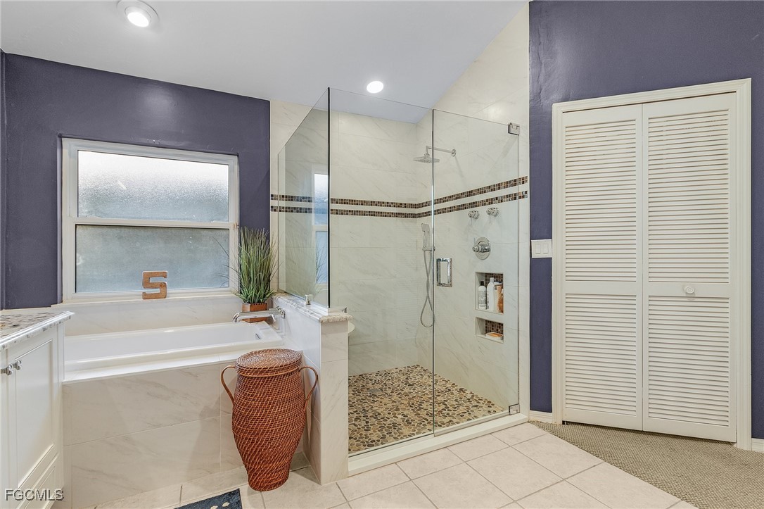 15661 Fiddlesticks Boulevard Fort Myers, FL 33912 - Photo 23 of 42 a bath room with a bath tub and a shower