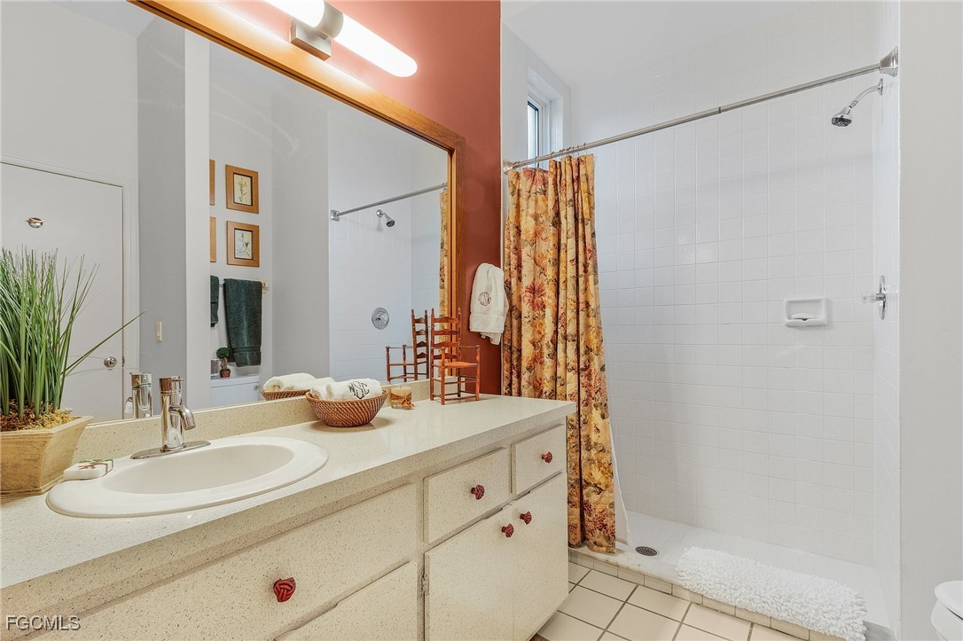 15661 Fiddlesticks Boulevard Fort Myers, FL 33912 - Photo 29 of 42 a bathroom with a double vanity sink mirror and shower