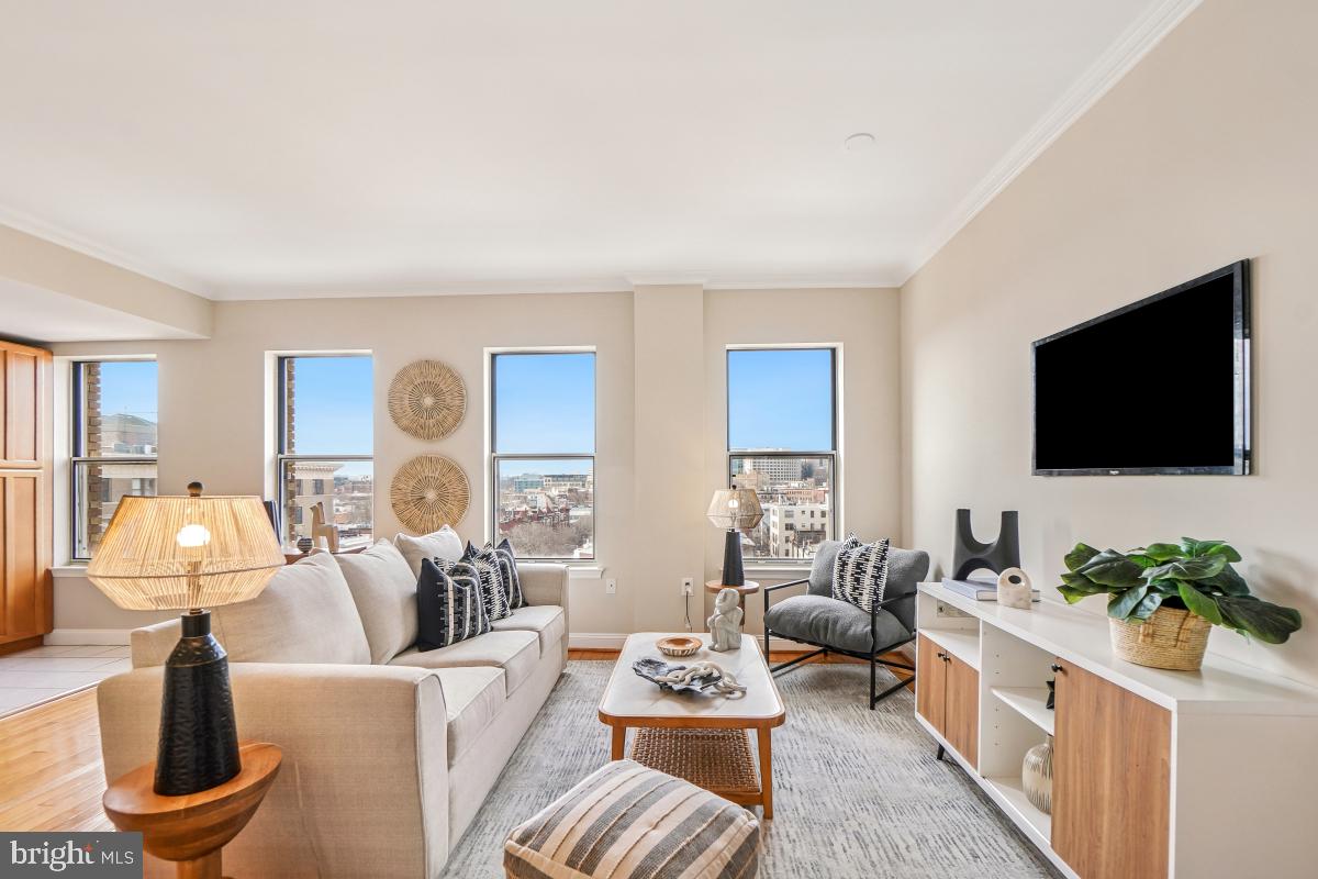 1621 T Street Northwest, Unit PH02 Washington, DC 20009 - Photo 6 of 30 a living room with furniture a flat screen tv and a floor to ceiling window