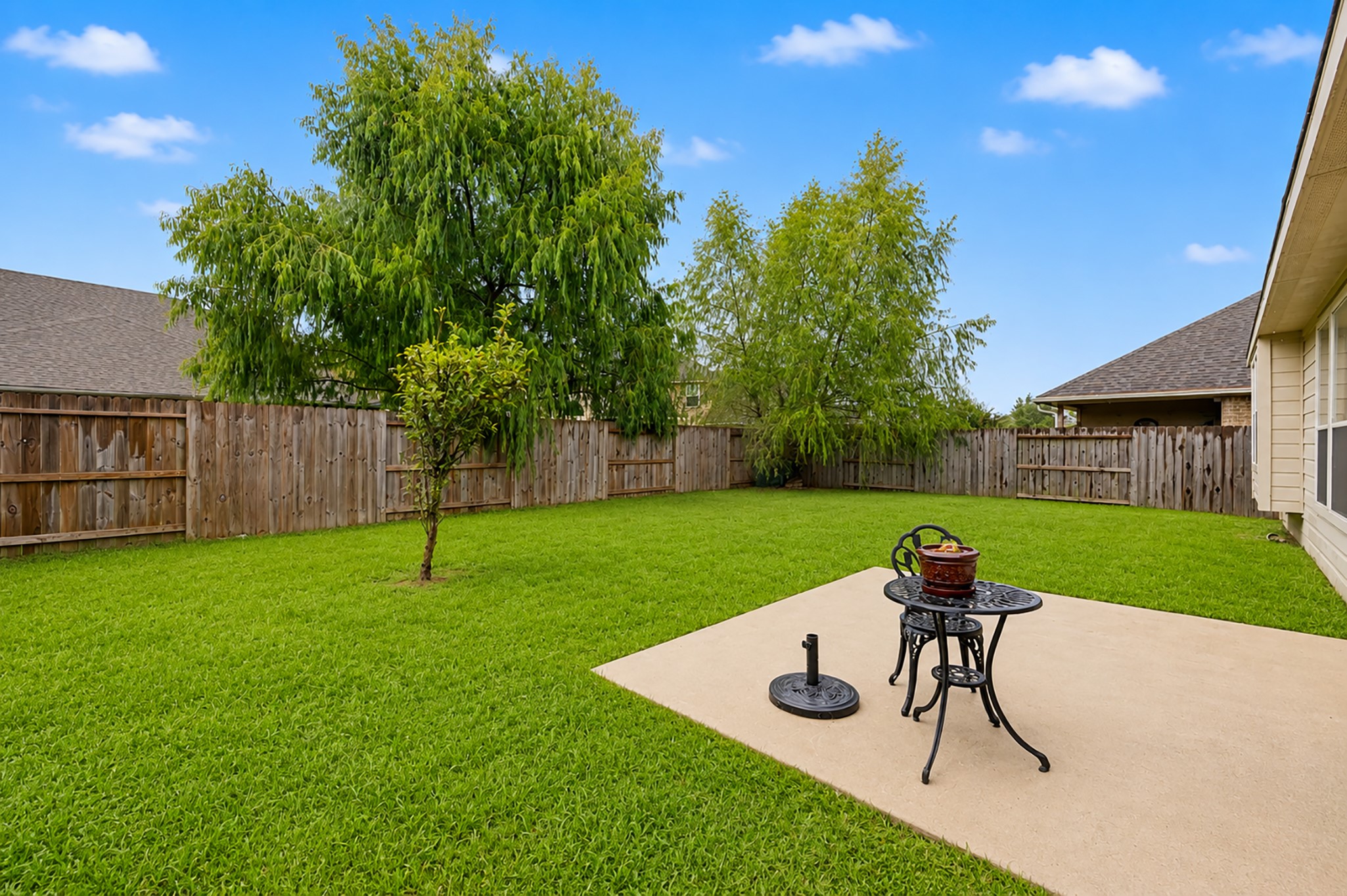 13035 Avery Ridge Lane Tomball, TX 77377 - Photo 23 of 27 Cozy patio area & spacious fenced backyard ideal for relaxing or entertaining.