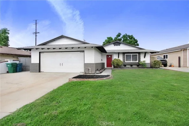 a front view of a house with a garden and plants