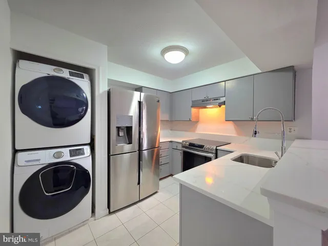 a kitchen with a sink a washer and dryer