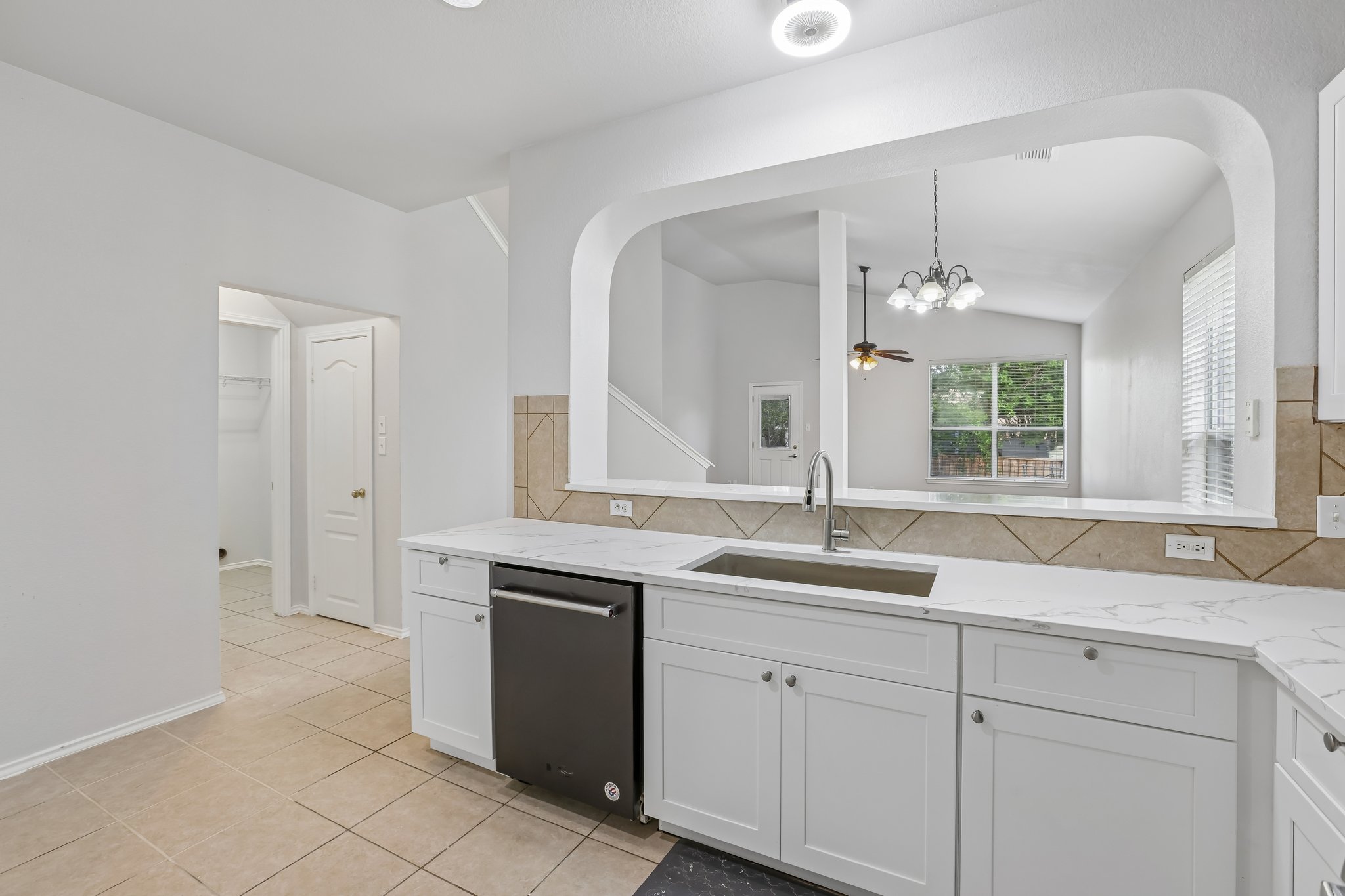 1721 Long Rifle Drive Austin, TX 78754 - Photo 11 of 38 Bright kitchen with white cabinetry and an open view to the living area.