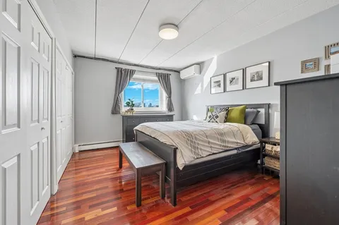 a bedroom with a bed and a painting on the wall