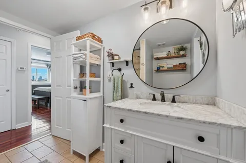 a bathroom with a sink mirror and vanity