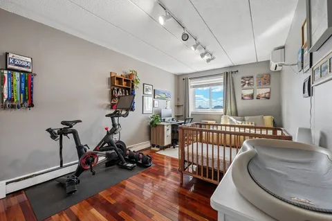 a bedroom with furniture window and wooden floor