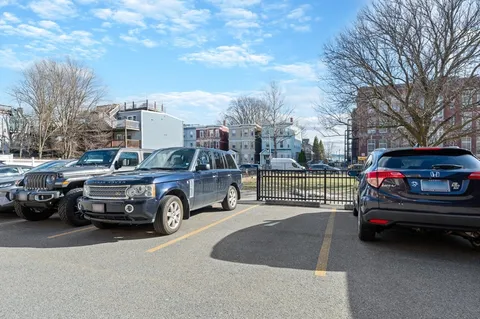 a view of a cars park in front of a house