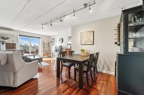 a view of a dining room with furniture window and wooden floor