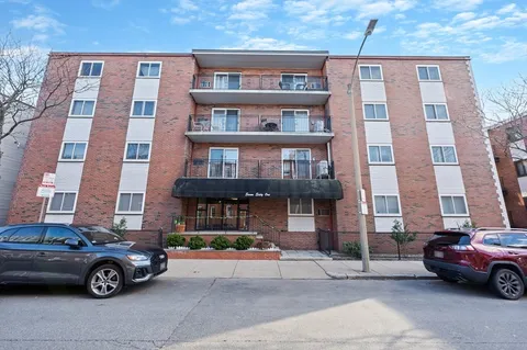 a car parked in front of a brick building