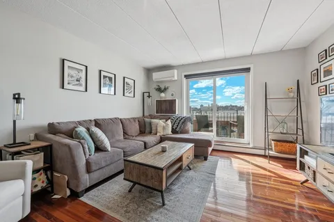 a living room with furniture and a floor to ceiling window