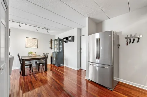 a kitchen with stainless steel appliances wooden floors and wooden cabinets
