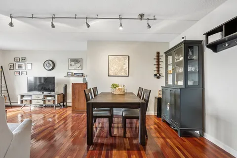 a view of a dining room with furniture and wooden floor