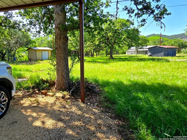 a view of a garden with a house in the background