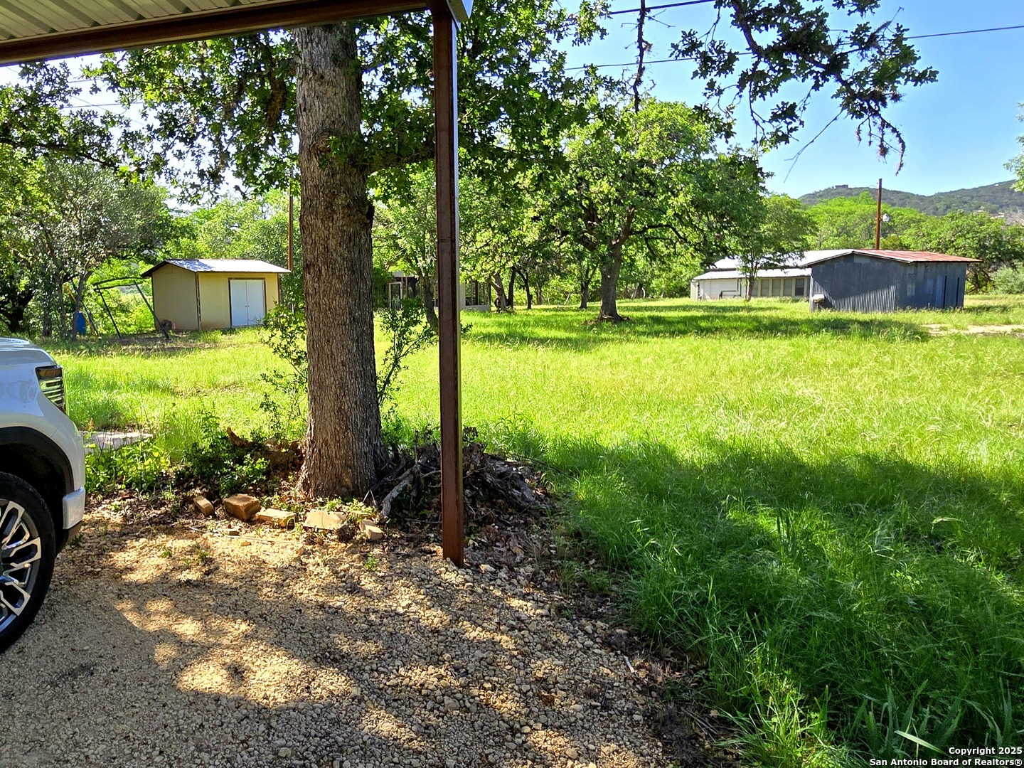 230 Rocky Top Road Medina, TX 78055 - Photo 16 of 37 a view of a garden with a house in the background