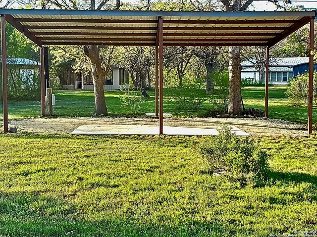 a view of a pathway of a house with a yard