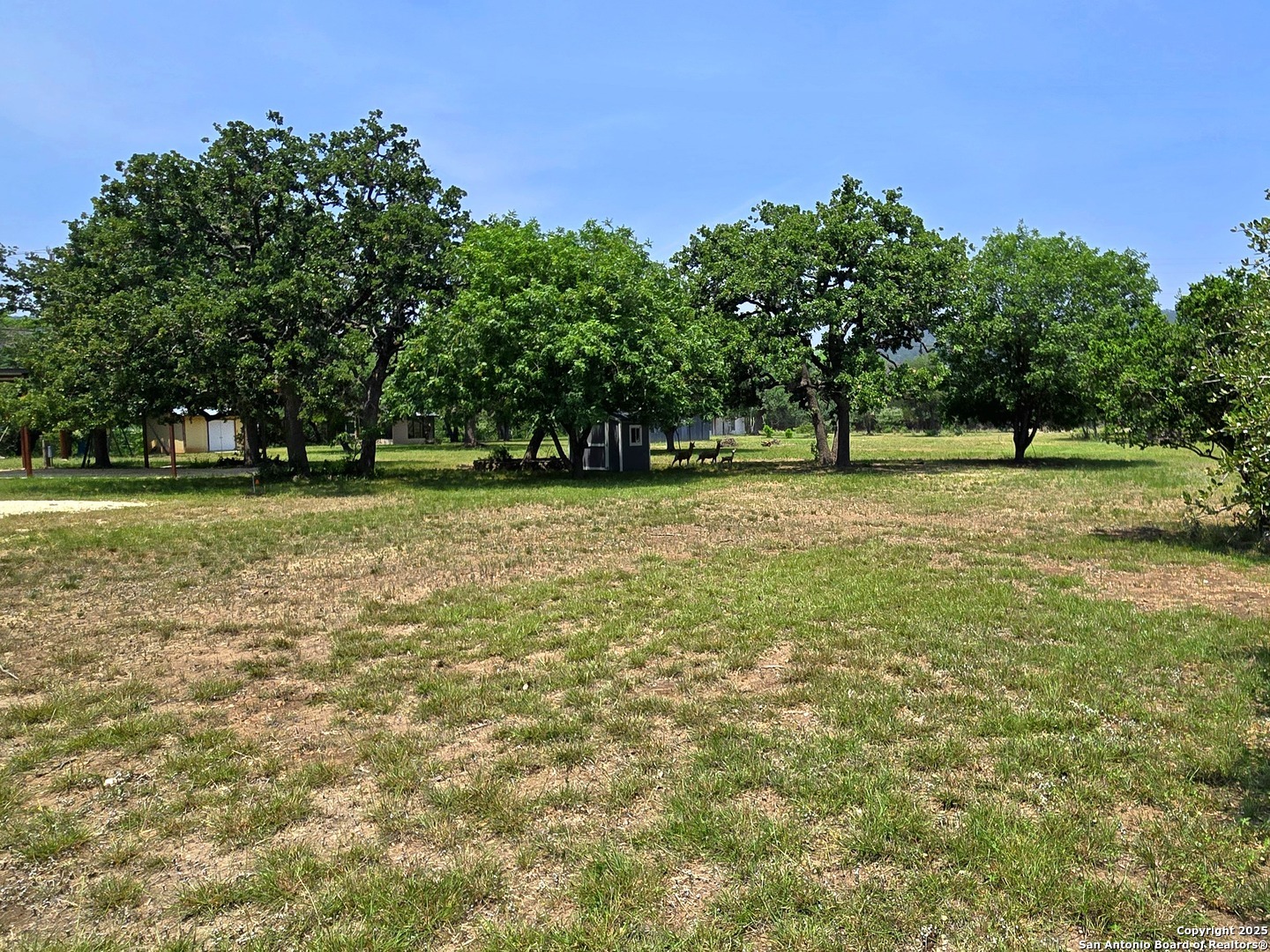 230 Rocky Top Road Medina, TX 78055 - Photo 24 of 37 a view of a green field with trees in the background