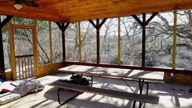 a view of a yard with wooden fence
