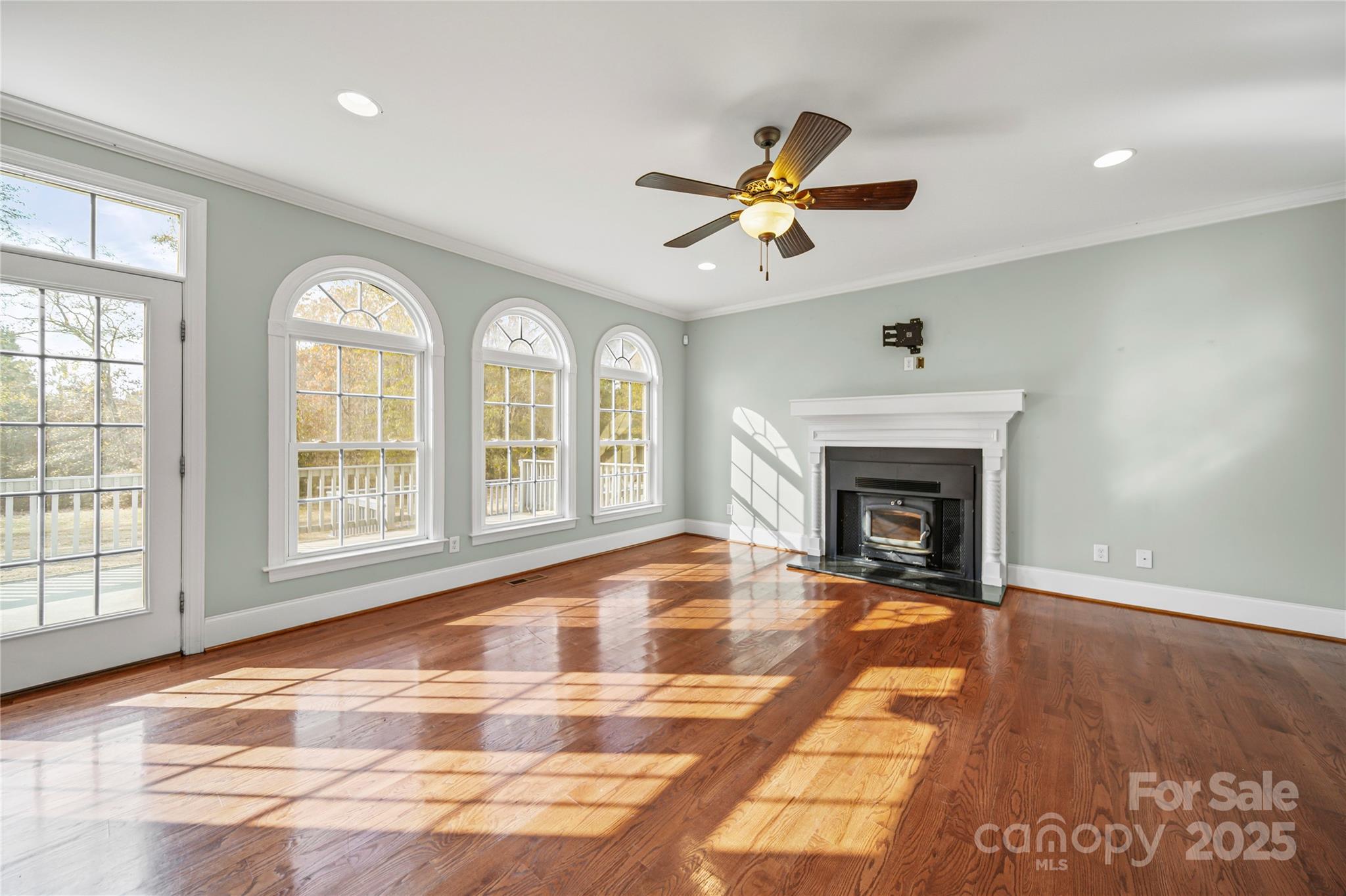 1556 Diggs Road Wadesboro, NC 28170 - Photo 11 of 48 a view of an empty room with a fireplace and windows