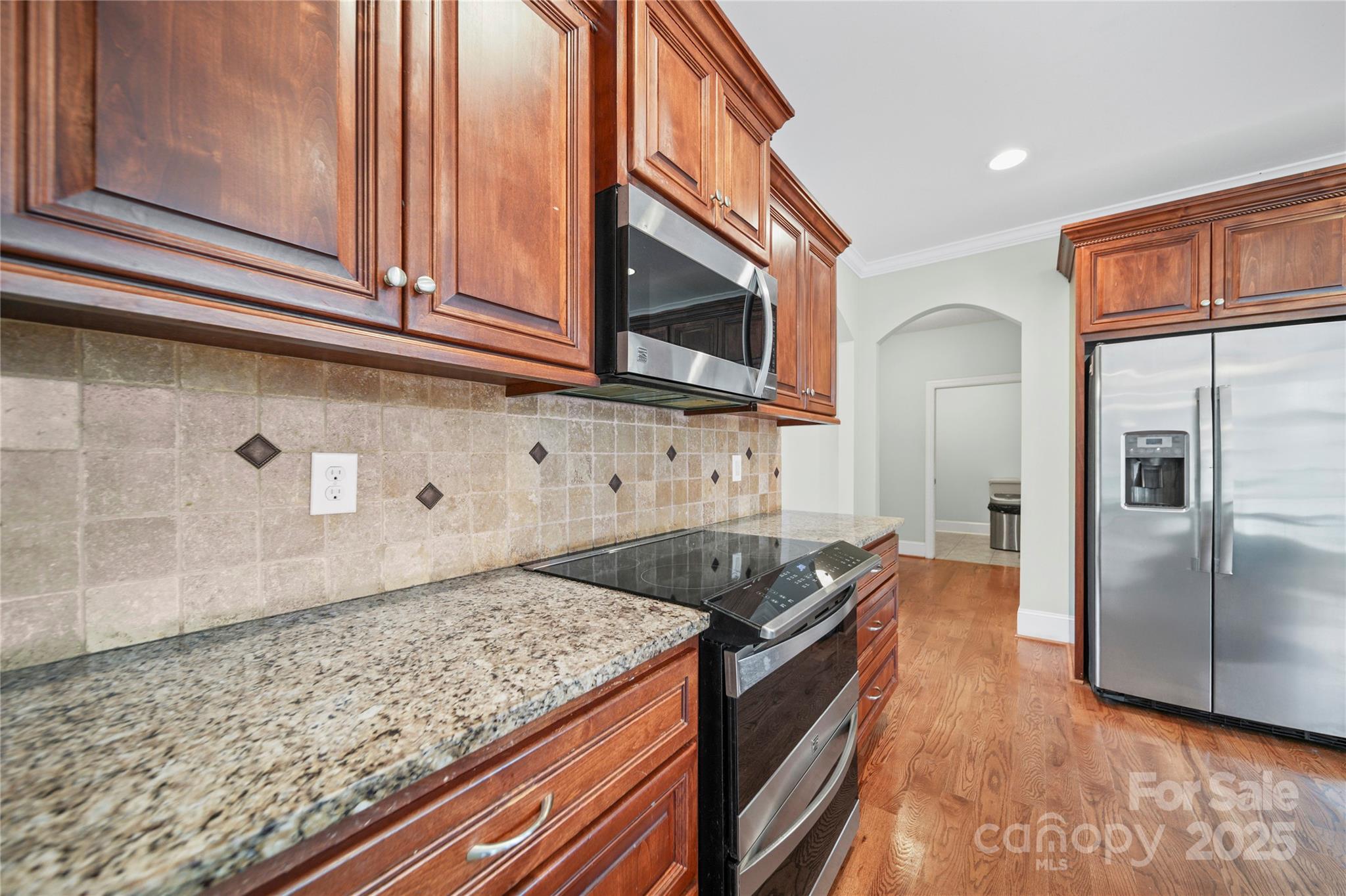 1556 Diggs Road Wadesboro, NC 28170 - Photo 17 of 48 a kitchen with stainless steel appliances granite countertop a sink stove and refrigerator