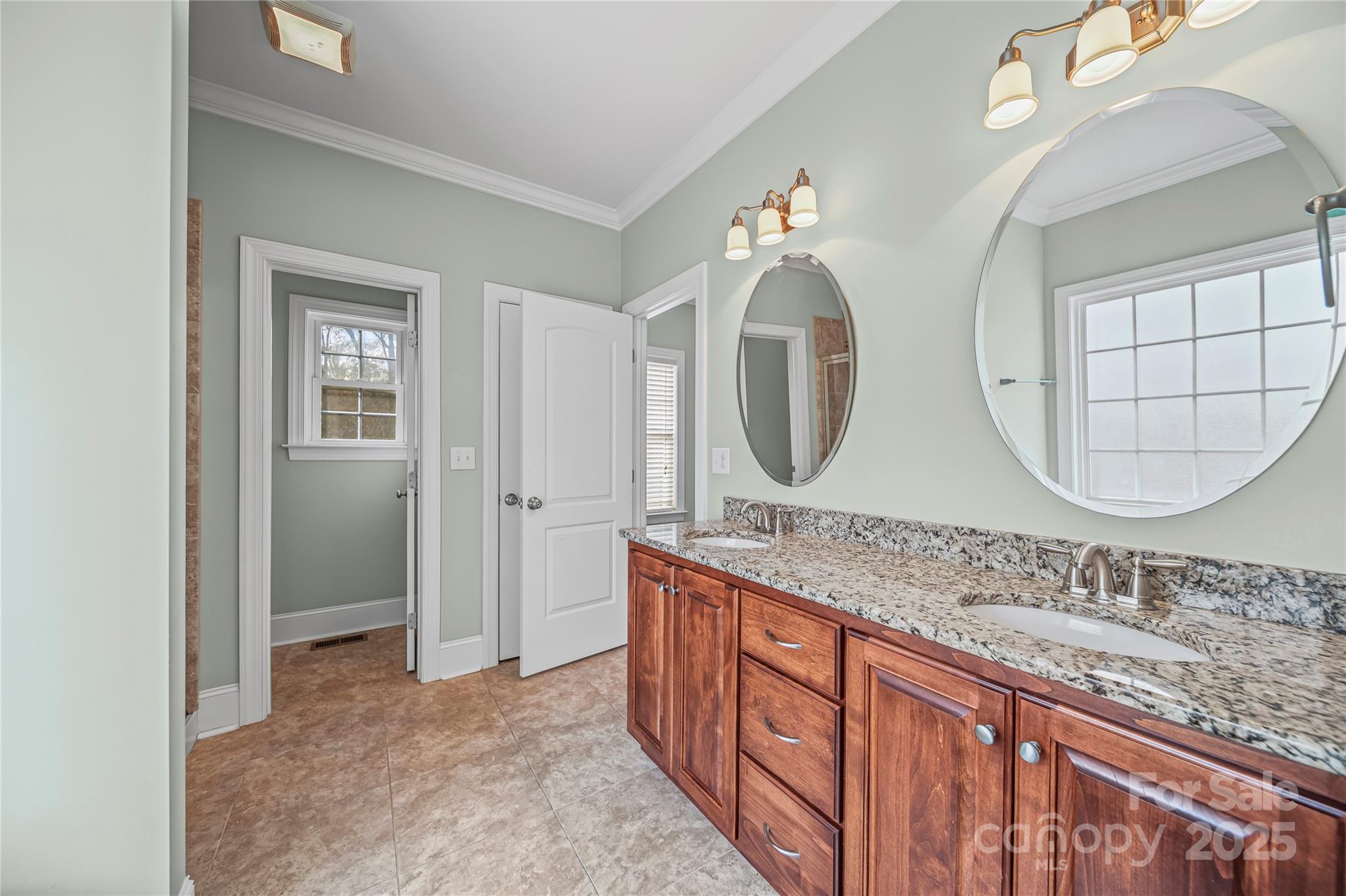 1556 Diggs Road Wadesboro, NC 28170 - Photo 26 of 48 a bathroom with a granite countertop double vanity sink and a mirror