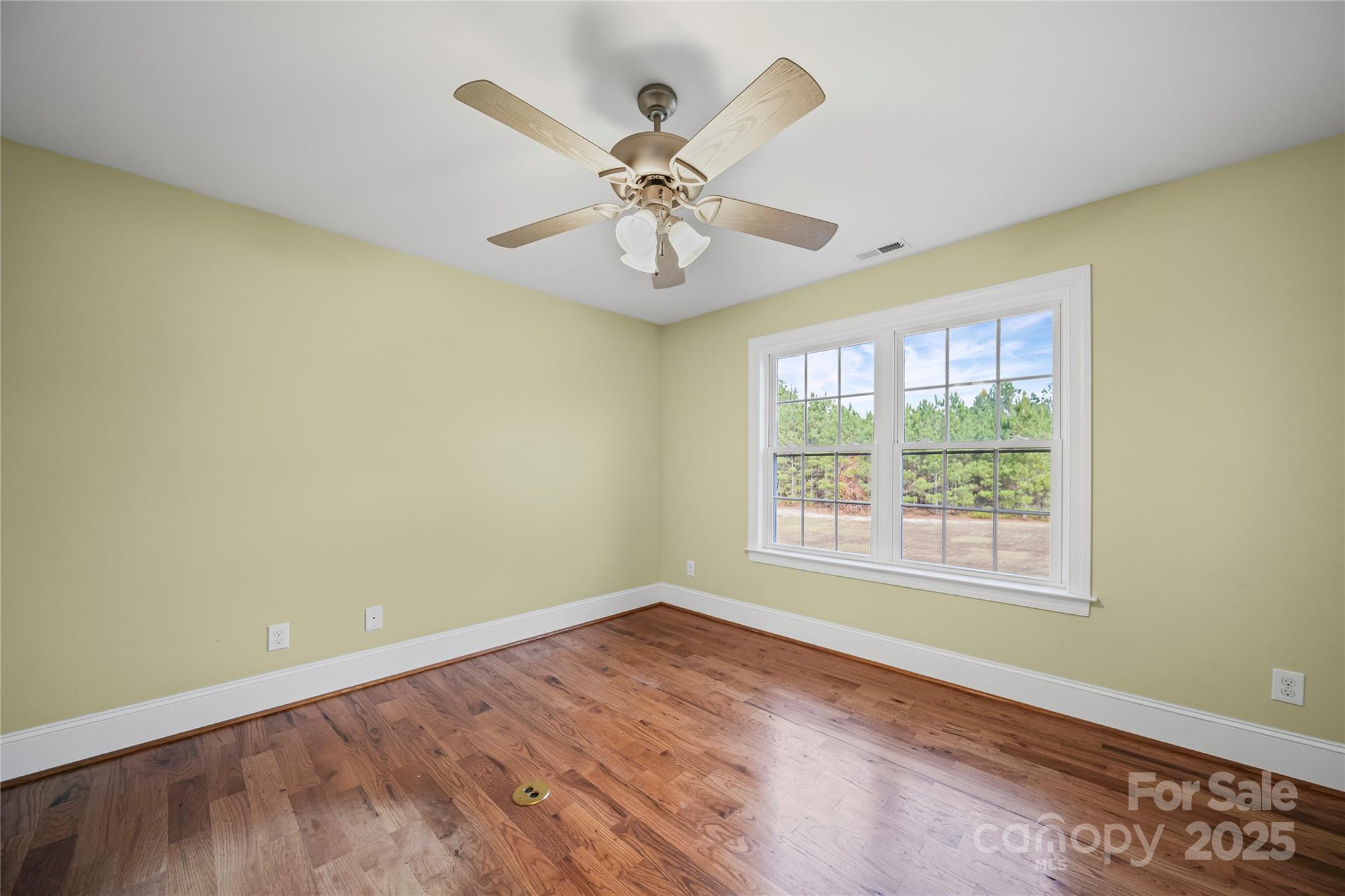 1556 Diggs Road Wadesboro, NC 28170 - Photo 27 of 48 a view of an empty room with chandelier fan and wooden floor