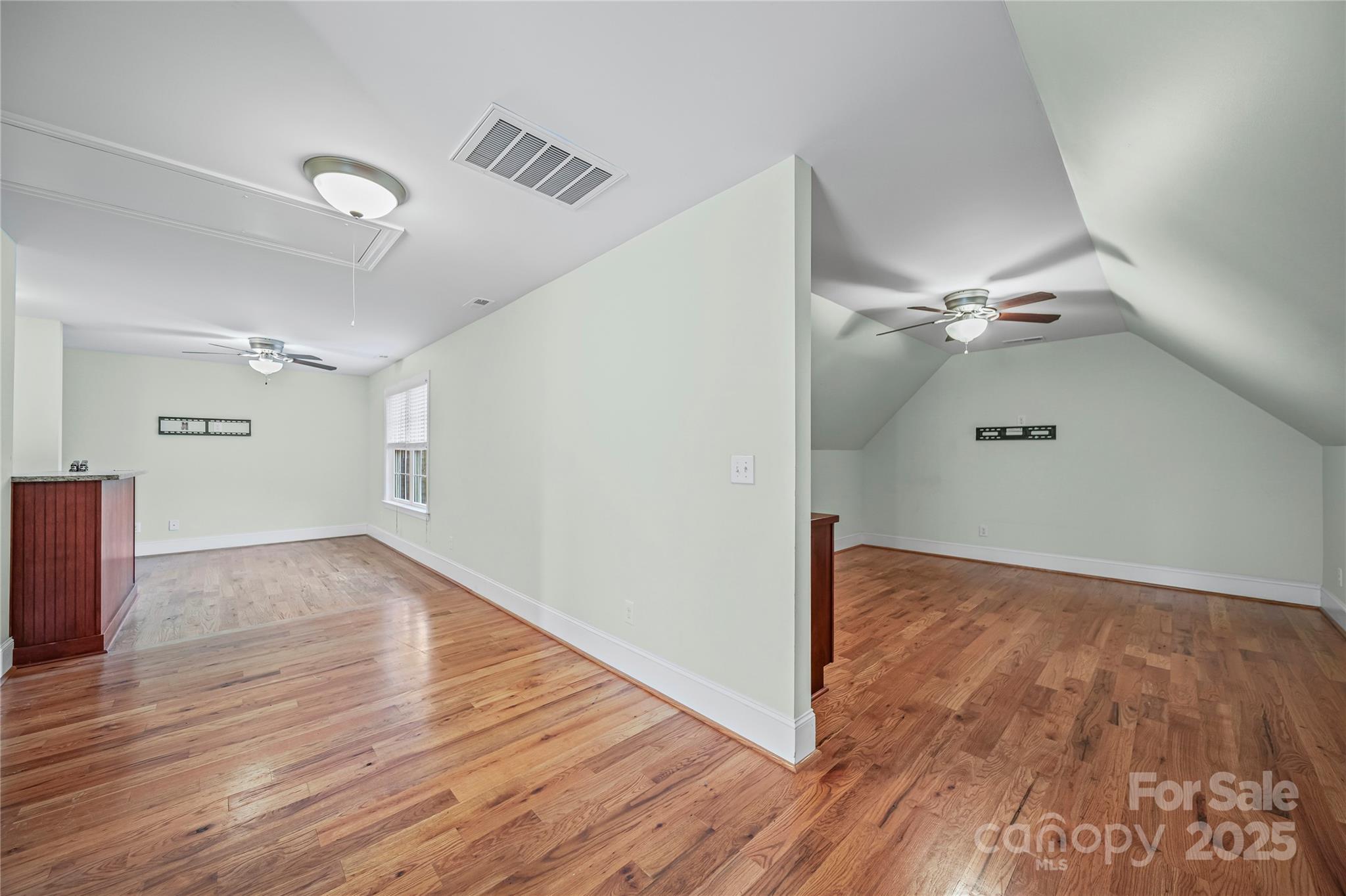 1556 Diggs Road Wadesboro, NC 28170 - Photo 41 of 48 an empty room with wooden floor and windows