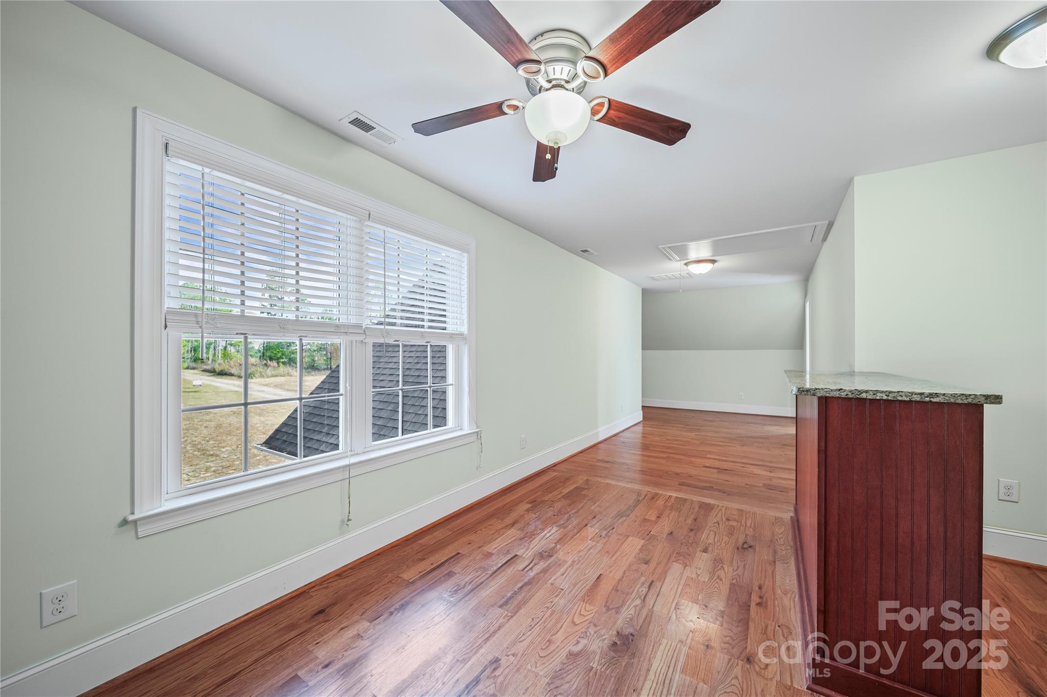 1556 Diggs Road Wadesboro, NC 28170 - Photo 42 of 48 a view of an empty room with a window and wooden floor
