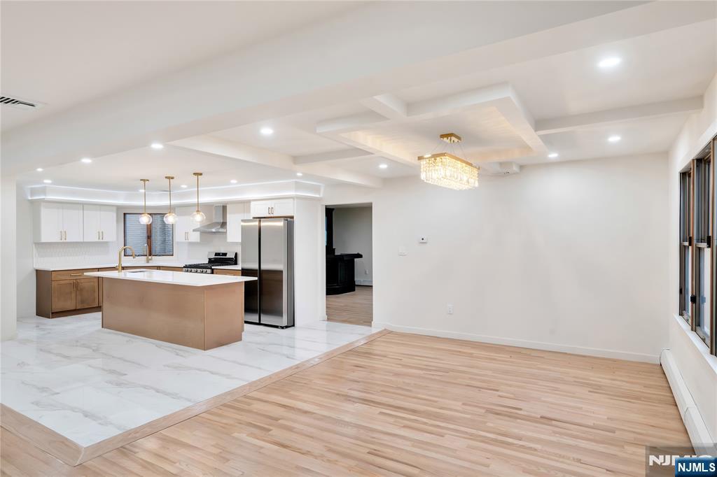 468 Morse Avenue Ridgefield, NJ 07657 - Photo 5 of 48 a large kitchen with stainless steel appliances kitchen island granite countertop a large counter top and wooden floors