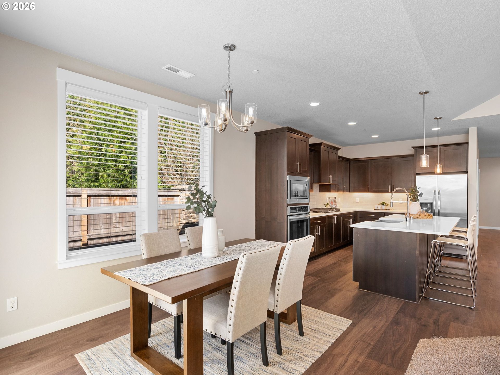 3709 Northeast Pioneer Street Camas, WA 98607 - Photo 11 of 30 a dining room with kitchen island stainless steel appliances furniture a large window and kitchen view