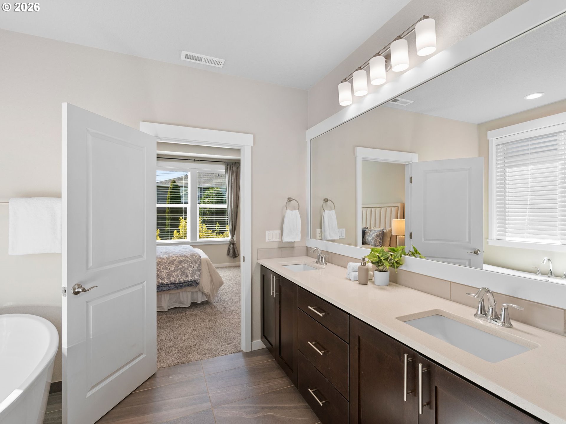 3709 Northeast Pioneer Street Camas, WA 98607 - Photo 16 of 30 a en suite bathroom with a double vanity sink a mirror and a bathtub