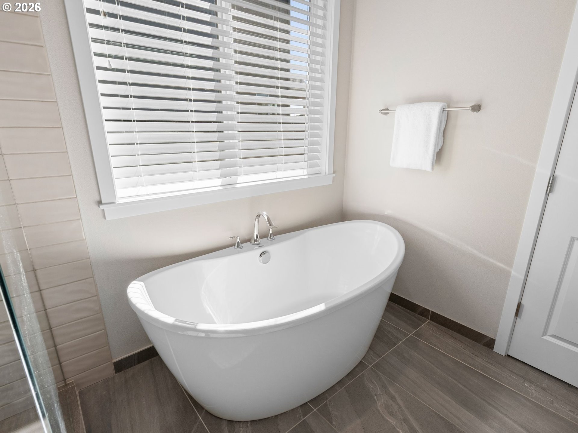 3709 Northeast Pioneer Street Camas, WA 98607 - Photo 19 of 30 a white bath tub sitting in a bathroom next to a window