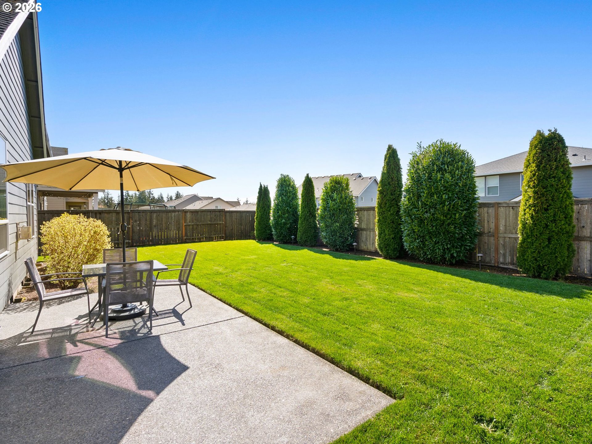 3709 Northeast Pioneer Street Camas, WA 98607 - Photo 26 of 30 a view of a patio with a table and chairs under an umbrella