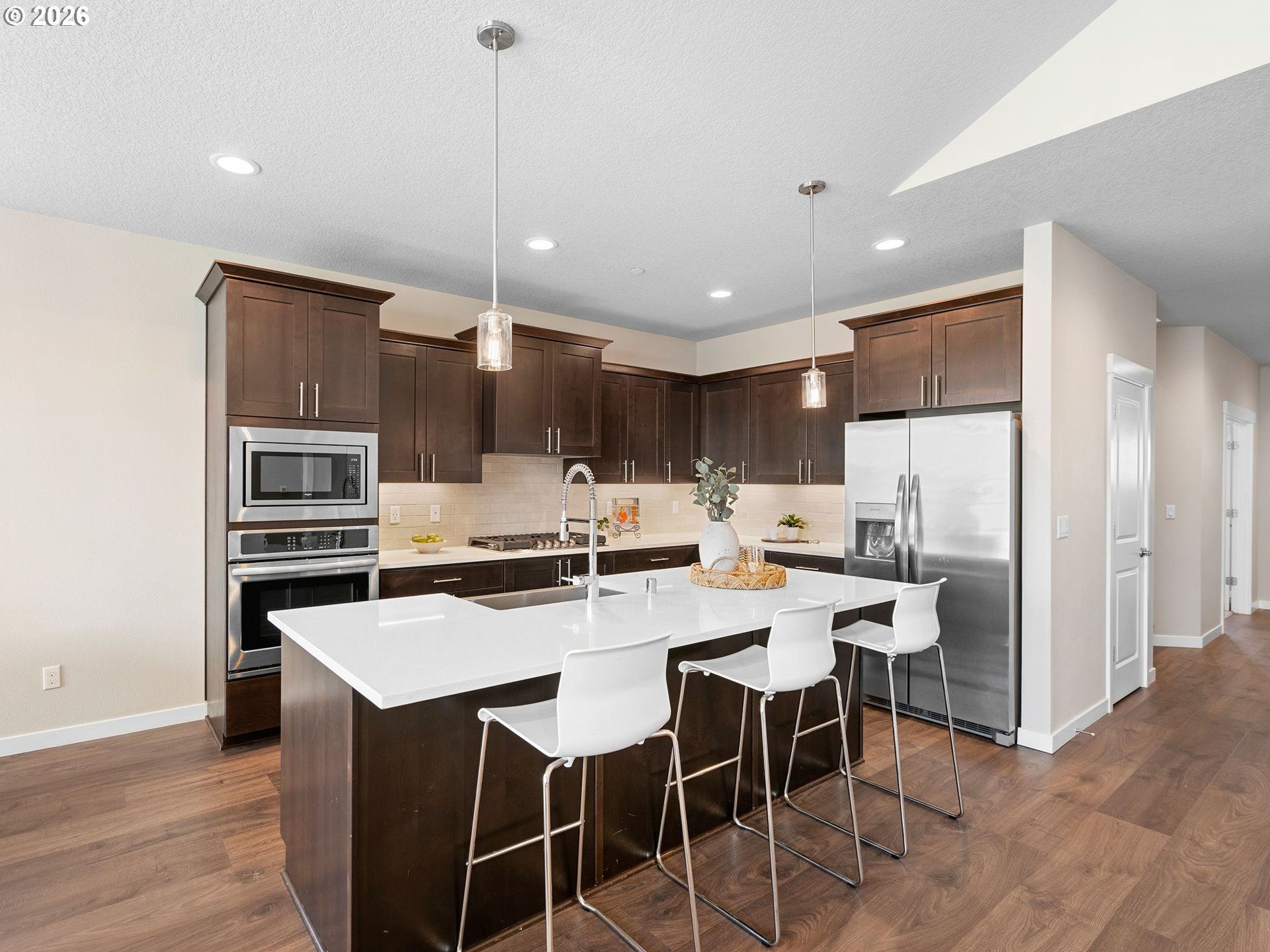 3709 Northeast Pioneer Street Camas, WA 98607 - Photo 7 of 30 a kitchen with stainless steel appliances a stove a sink island and a refrigerator