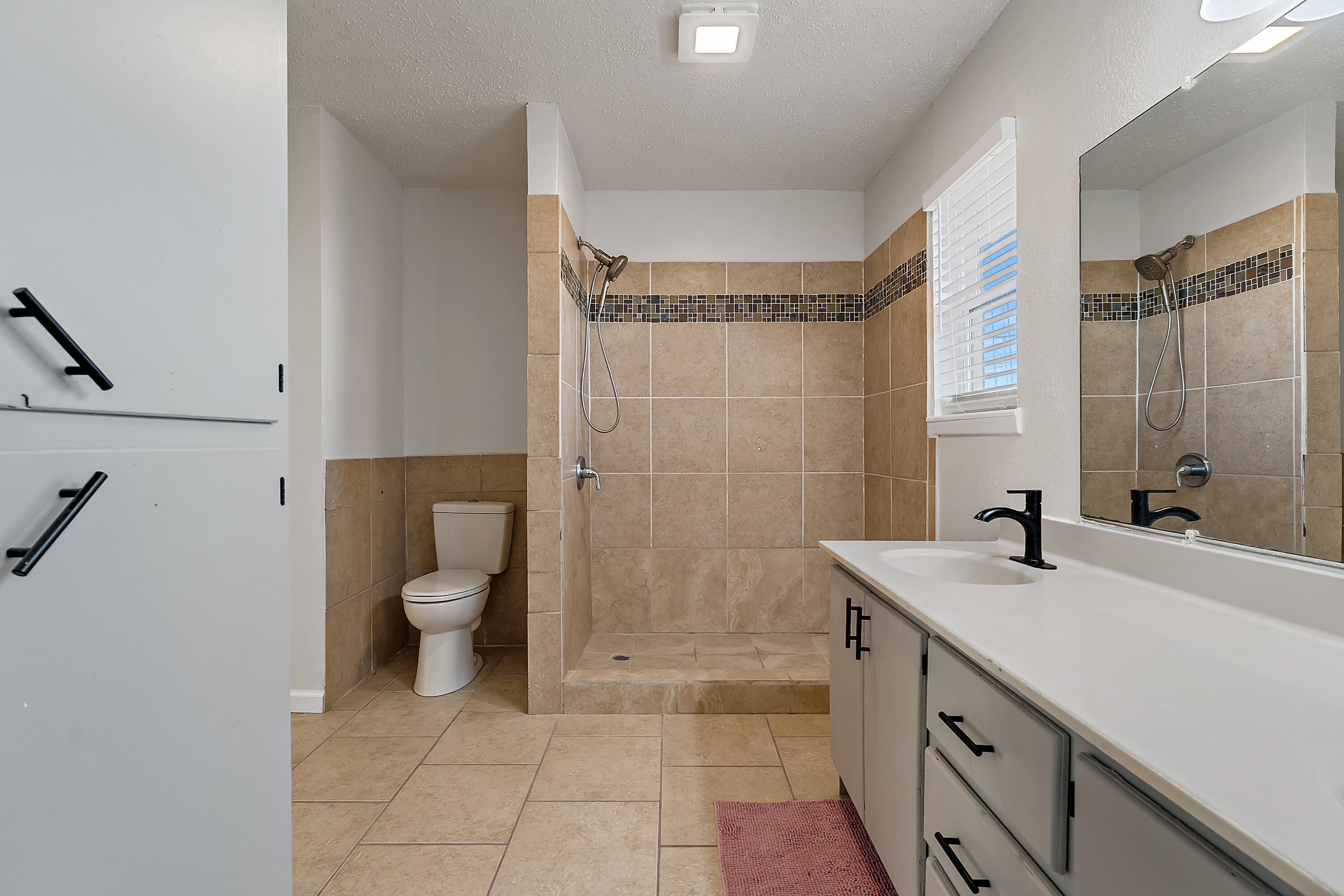 726 11th Street Wolfforth, TX 79382 - Photo 13 of 22 a bathroom with a sink a toilet and shower