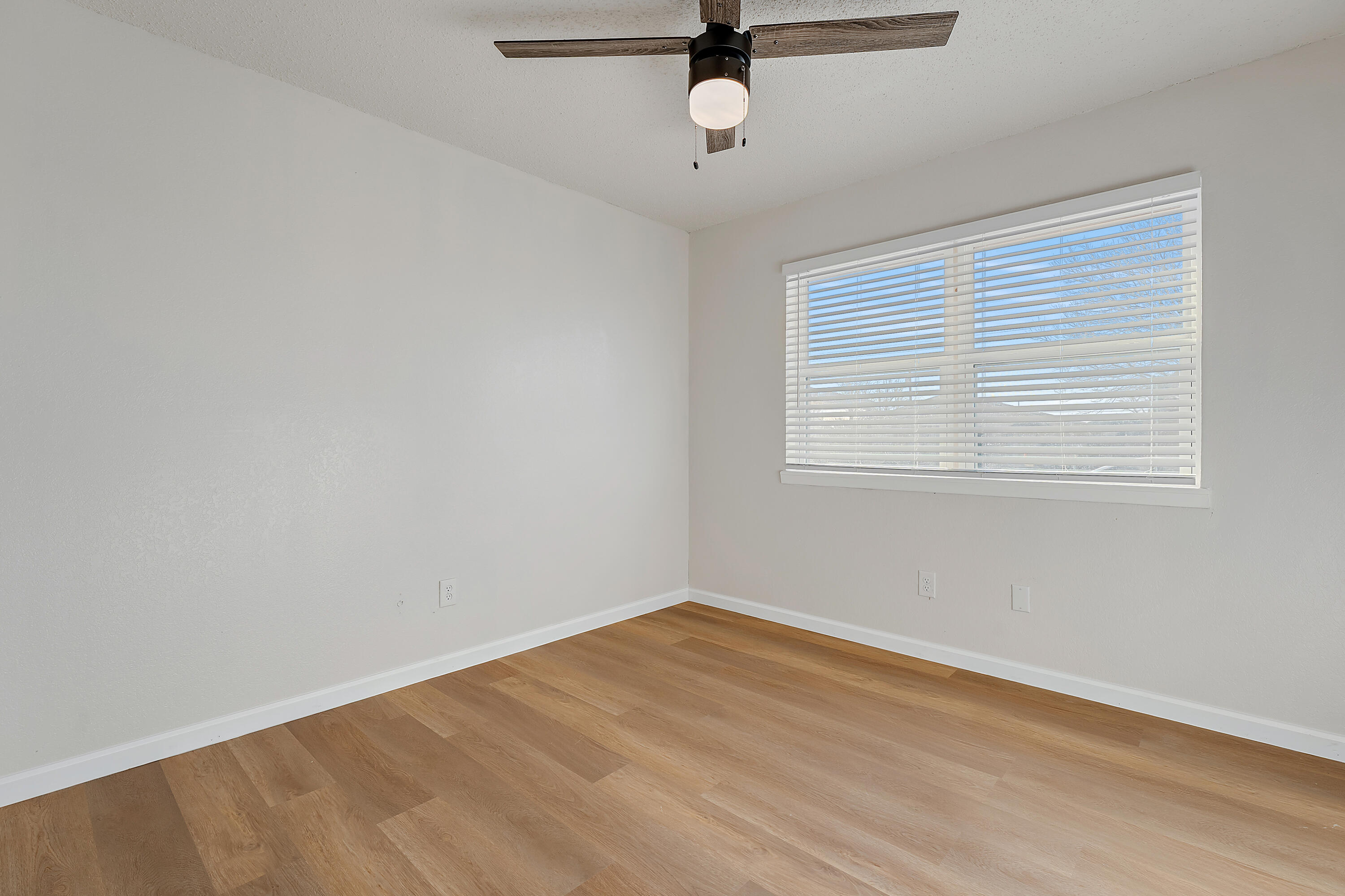 726 11th Street Wolfforth, TX 79382 - Photo 15 of 22 wooden floor in an empty room with a window