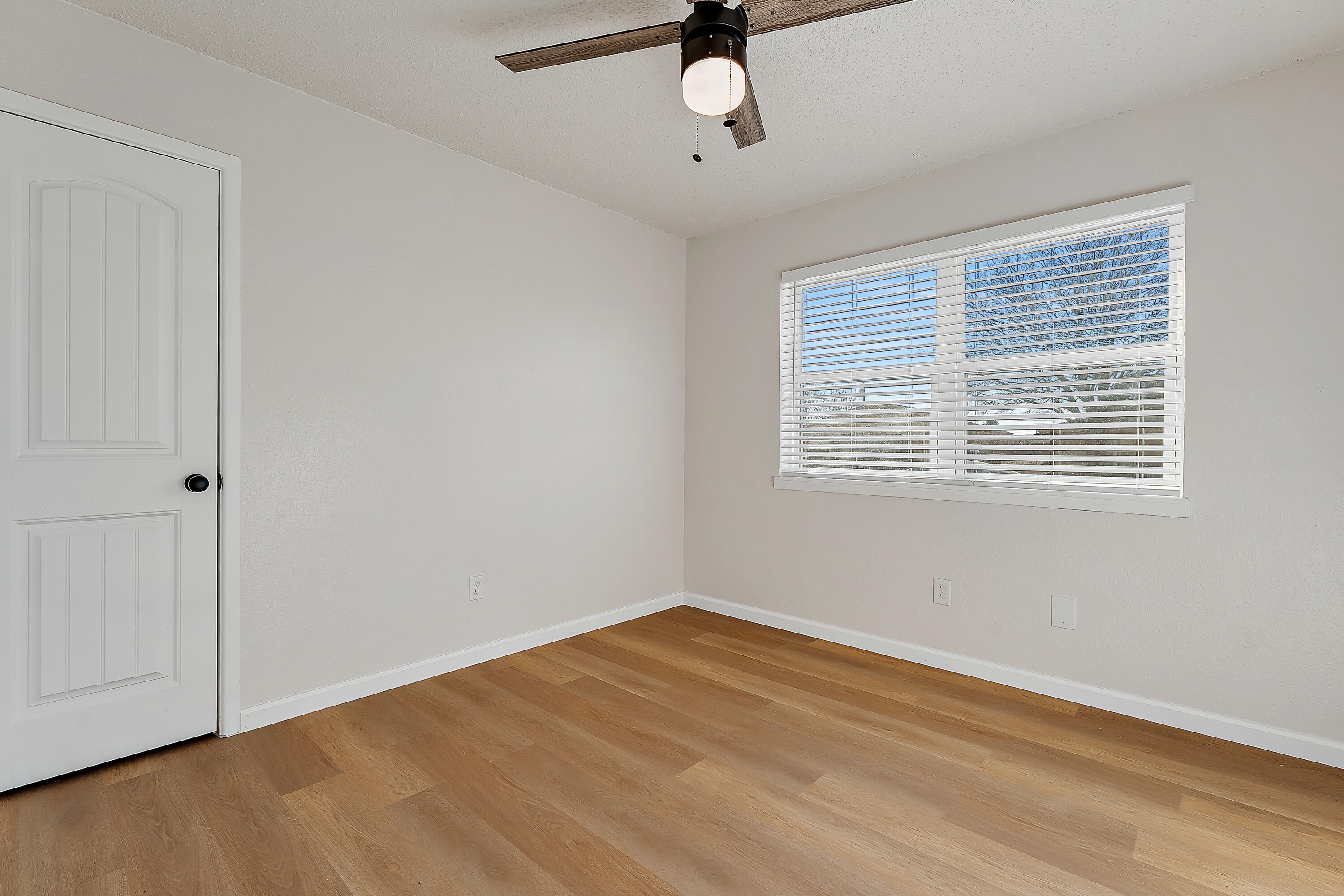 726 11th Street Wolfforth, TX 79382 - Photo 17 of 22 a view of empty room with wooden floor and fan
