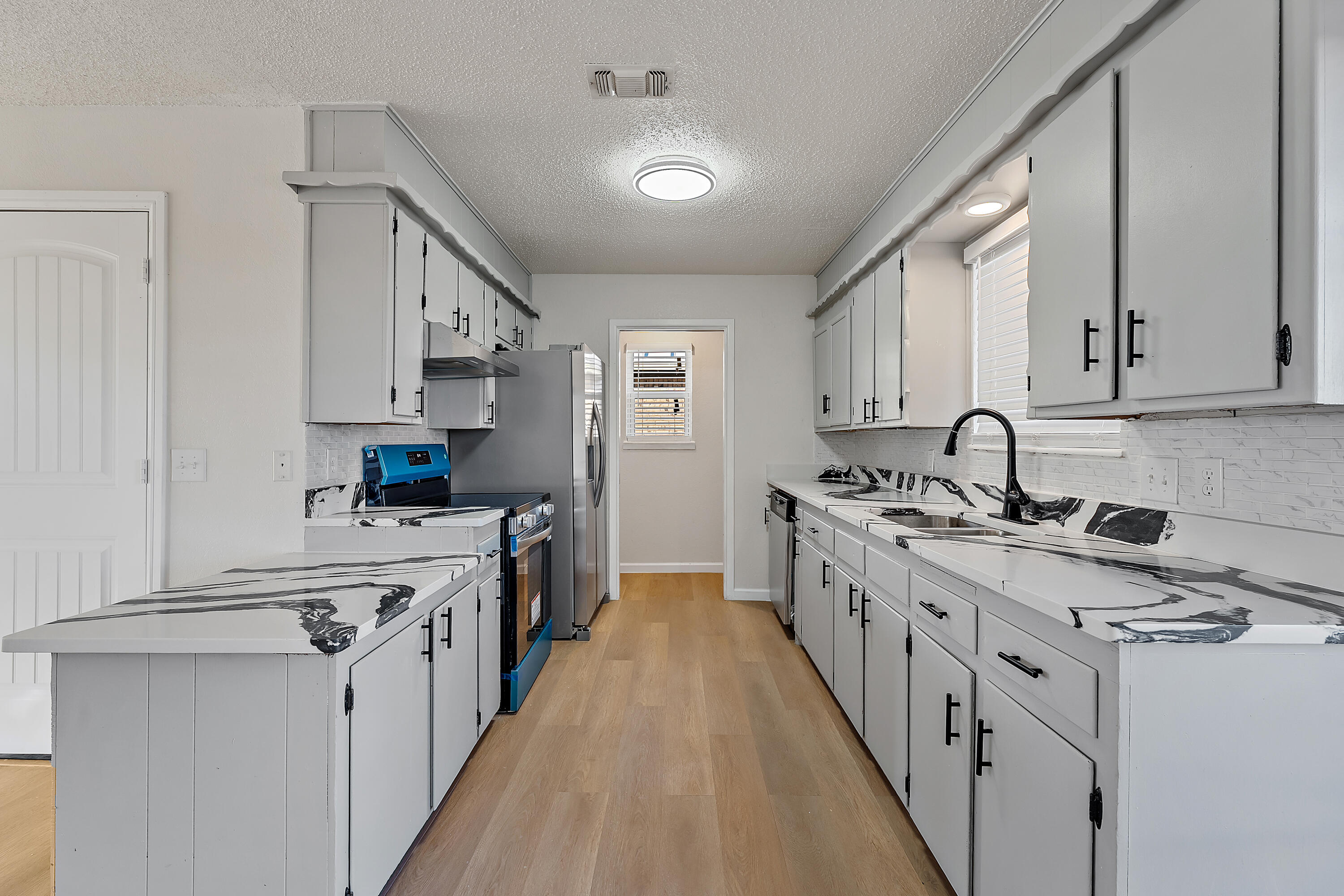 726 11th Street Wolfforth, TX 79382 - Photo 8 of 22 a kitchen with stainless steel appliances a sink stove top oven and cabinets