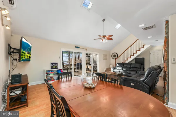 a living room with furniture a rug and a large window